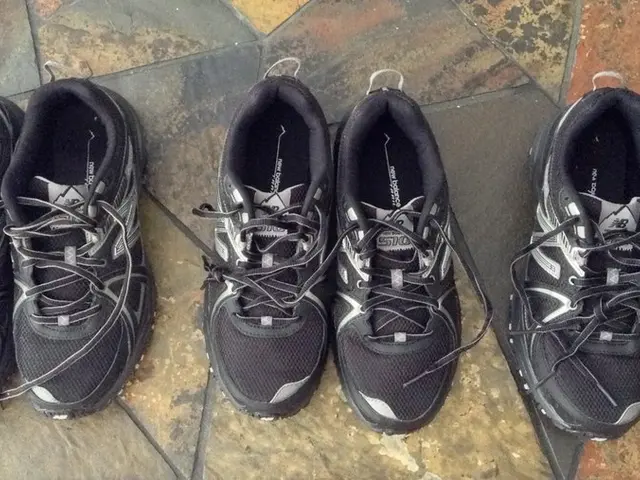 In this image we can see three pairs of shoes on the floor.